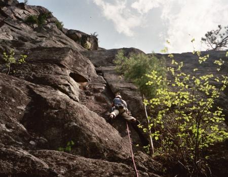 A climber goes up a rock route