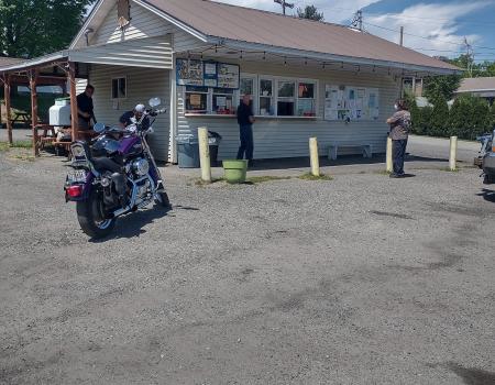 a snack bar in a parking lot on a sunny day. 