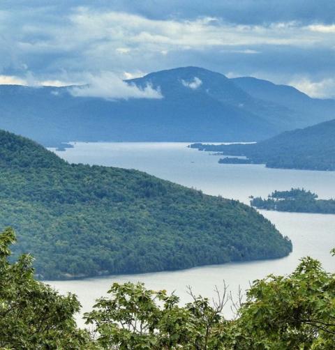 Looking down into a misty lake valley surrounded by mountains.