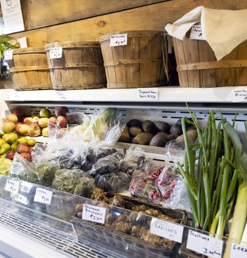 An bunch of farm grown veggies in a store