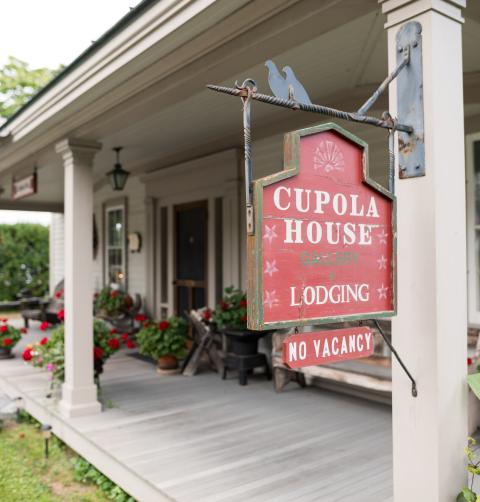 Lake Champlain Region featuring the exterior of the Cupola House lodging and signage.