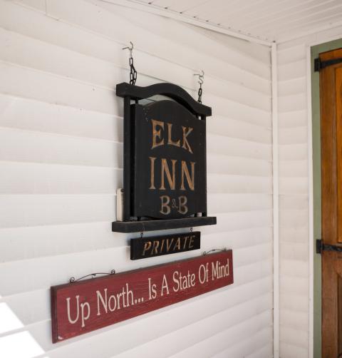 Signage for Elk Inn lodging.