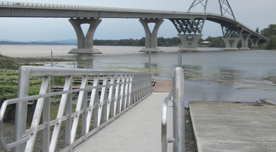 A boat launch in the shadow of a bridge