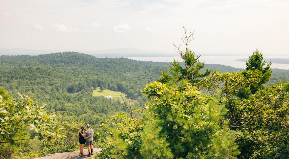 Two people on the summit of Coon Mountain