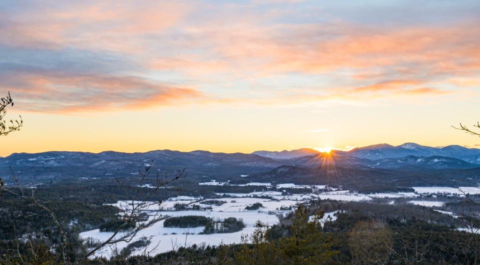 The view from Coon Mountain during a winter sunset.