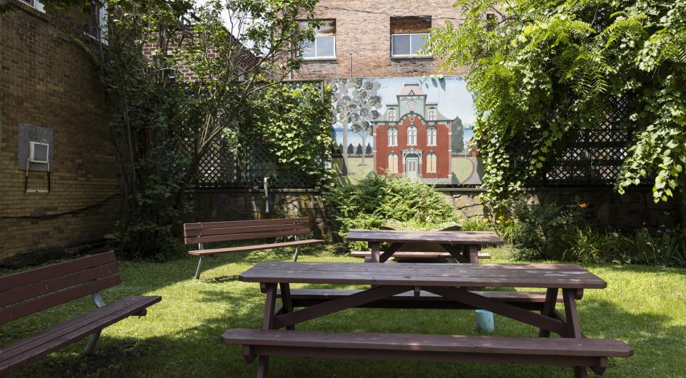 A mural at a small park with picnic tables