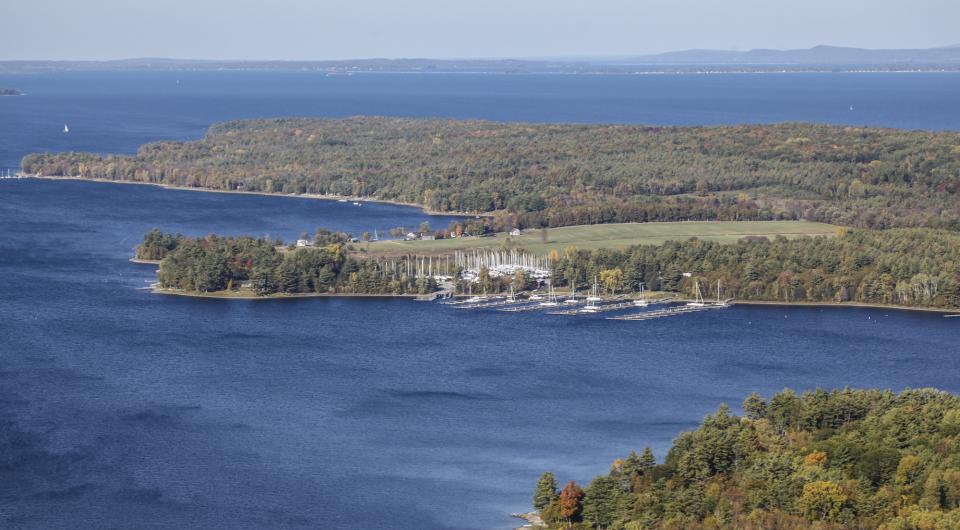 Aerial view of a peninsula on Lake Champlain in the fall.