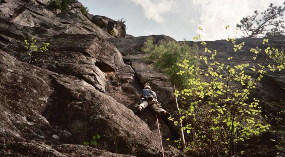 A climber goes up a rock route