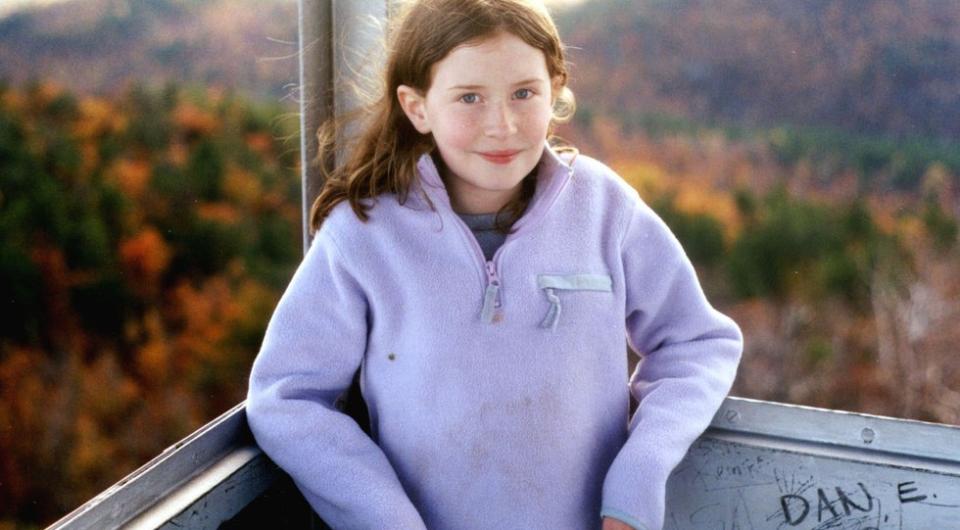 Girl standing in a firetower during Autumn