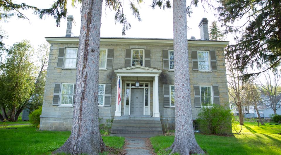 A historic building framed by two large trees