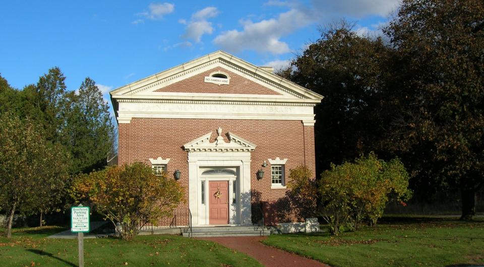 The decoration above the front door is known as a scroll pediment.