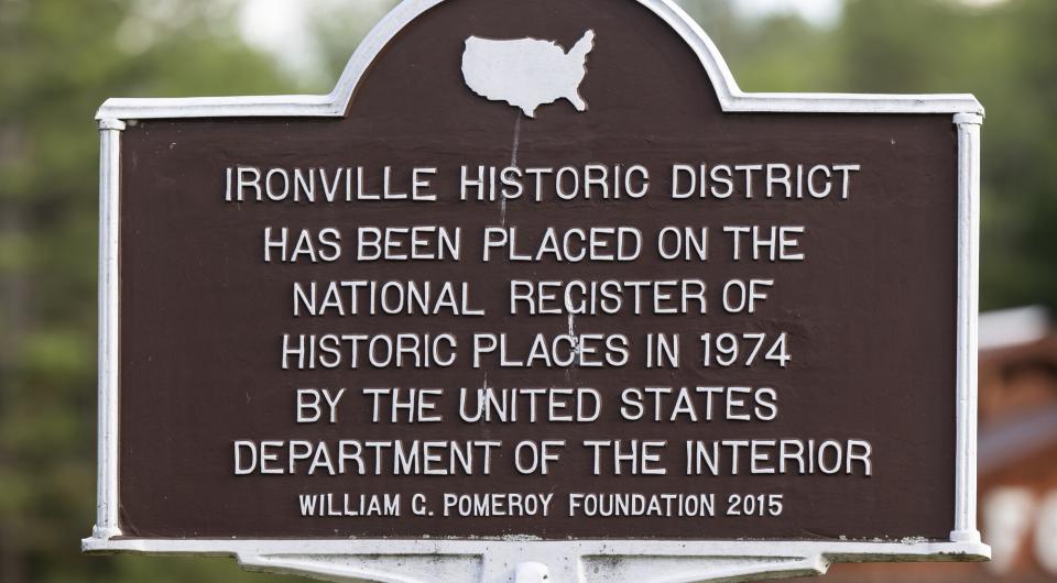 A brown metal historic sign for the Ironville Historic District