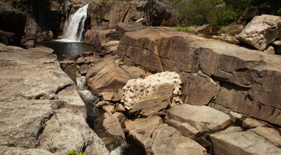 A single waterfall flowing into a pool of water