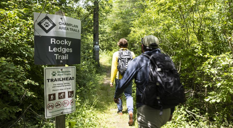 Two hikers head out onto the Rocky Ledges Trail.