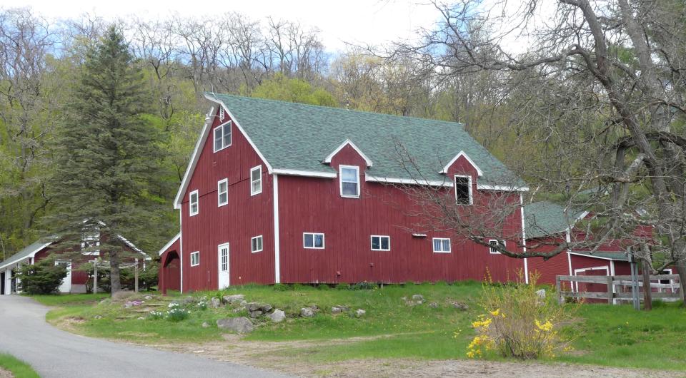 A red barn on the side of a cycling route.