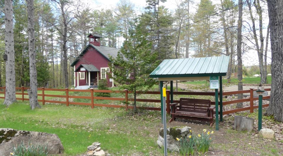 A small farm with red fence.