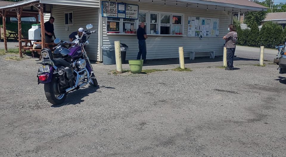 a snack bar in a parking lot on a sunny day. 