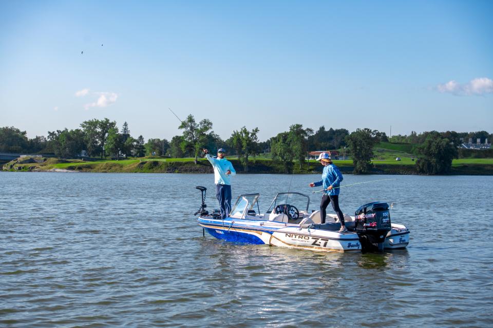 man fishing off his boat