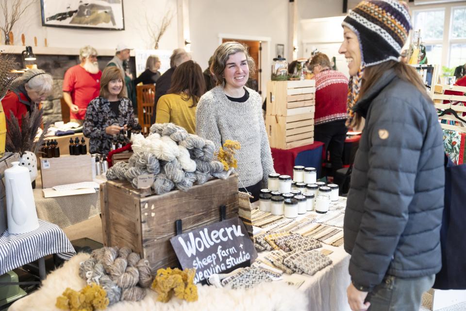 woman selling yarn from her farm at craft fair in essex