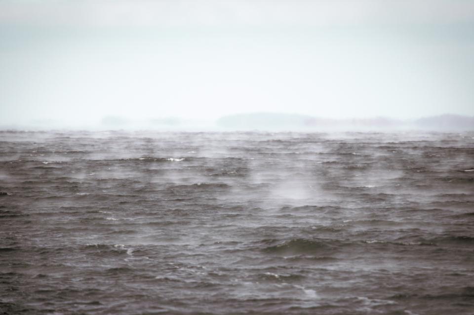 A spooky view across Lake Champlain, with only waves and fog visable.