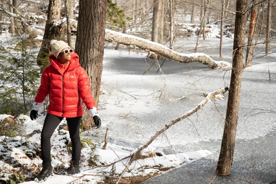 Woman stands in the snowy woods