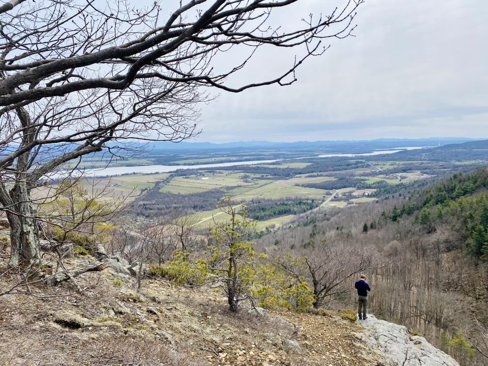 A view into a valley of farmland and Lake Champlain