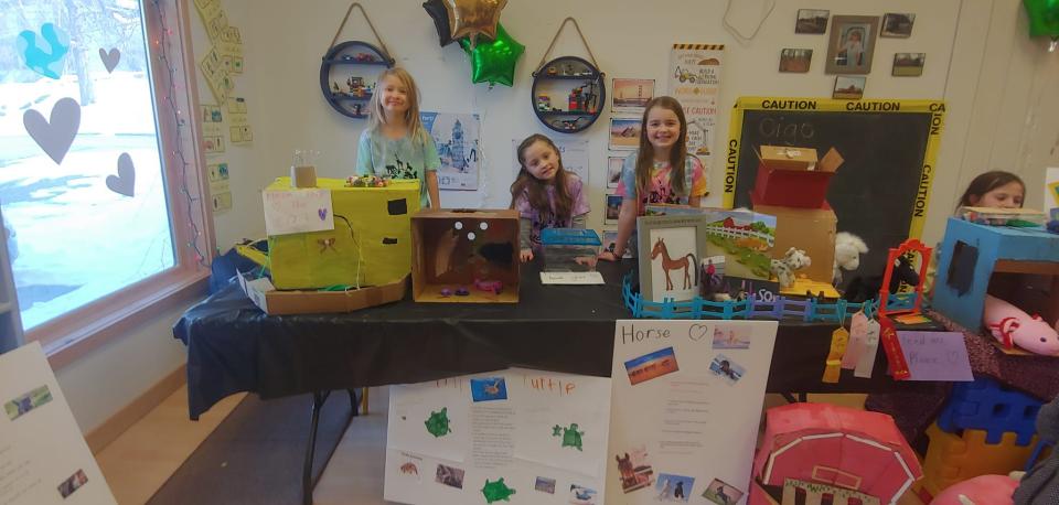 Children displaying wildlife exhibits in a classroom