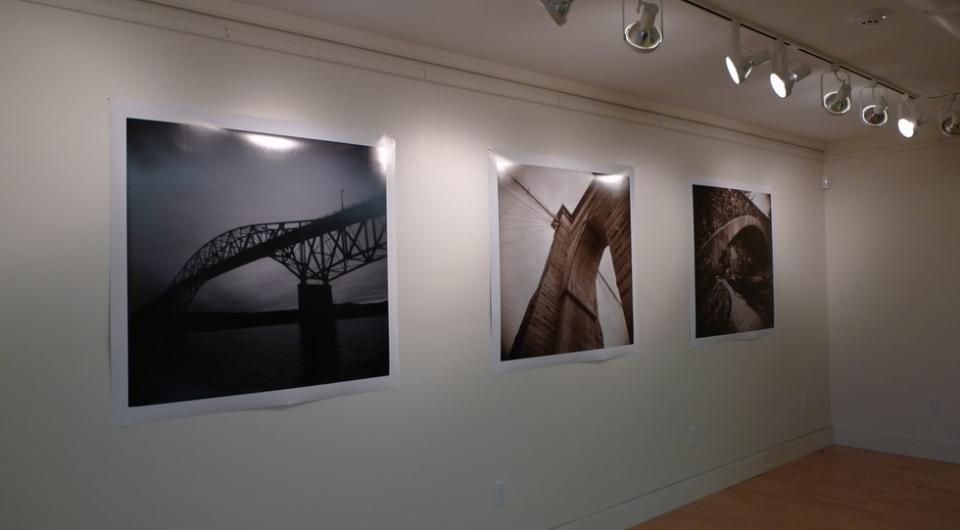 A wall with three photographed images on it.