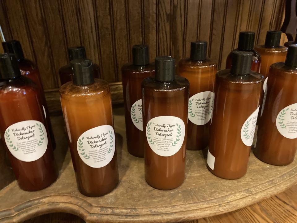 A wooden shelf full of dish detergents