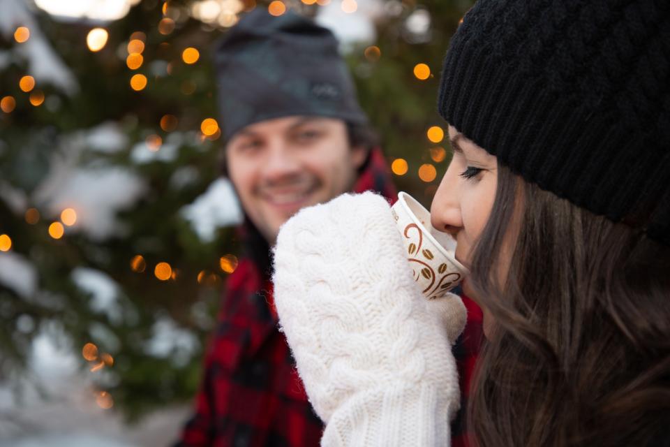 A woman sips on hot cocoa.