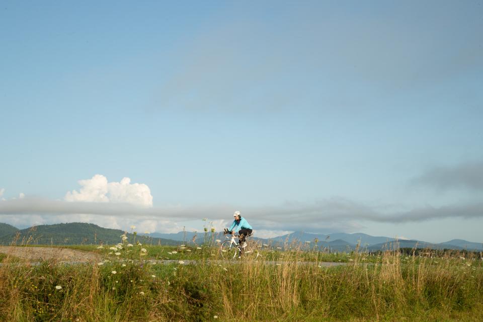 A woman cycling through the hills during morning