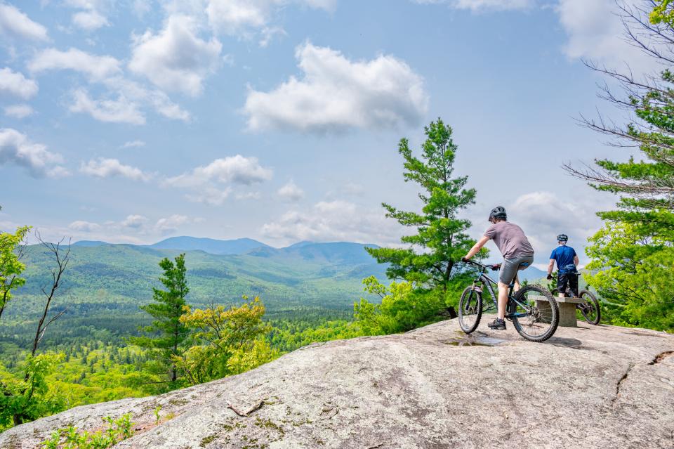 Two bikers on top of a rocky summit