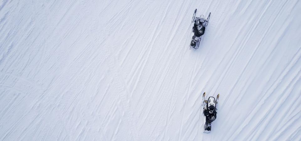 Two snowmobiles from an aerial view