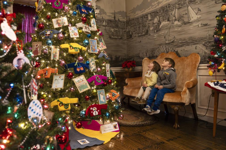 Kids look at decorated Christmas trees