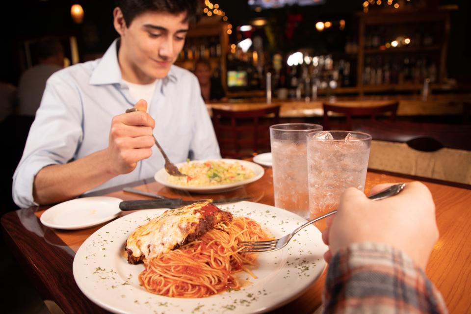 A man eating food at Burgoyne Grill