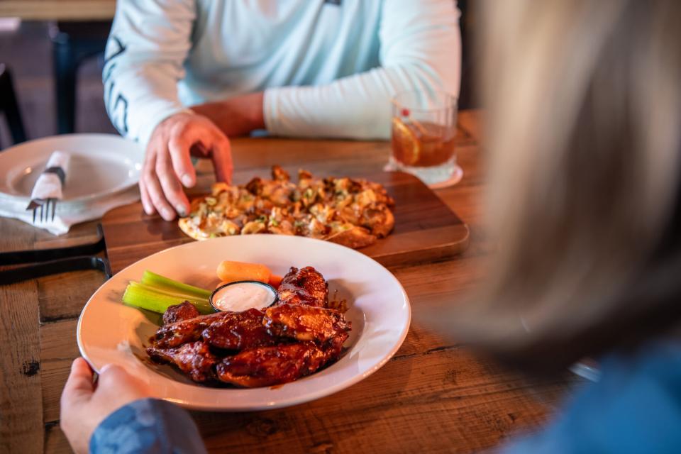 A couple plates of food on the table for a couple at War Cannon Spirits