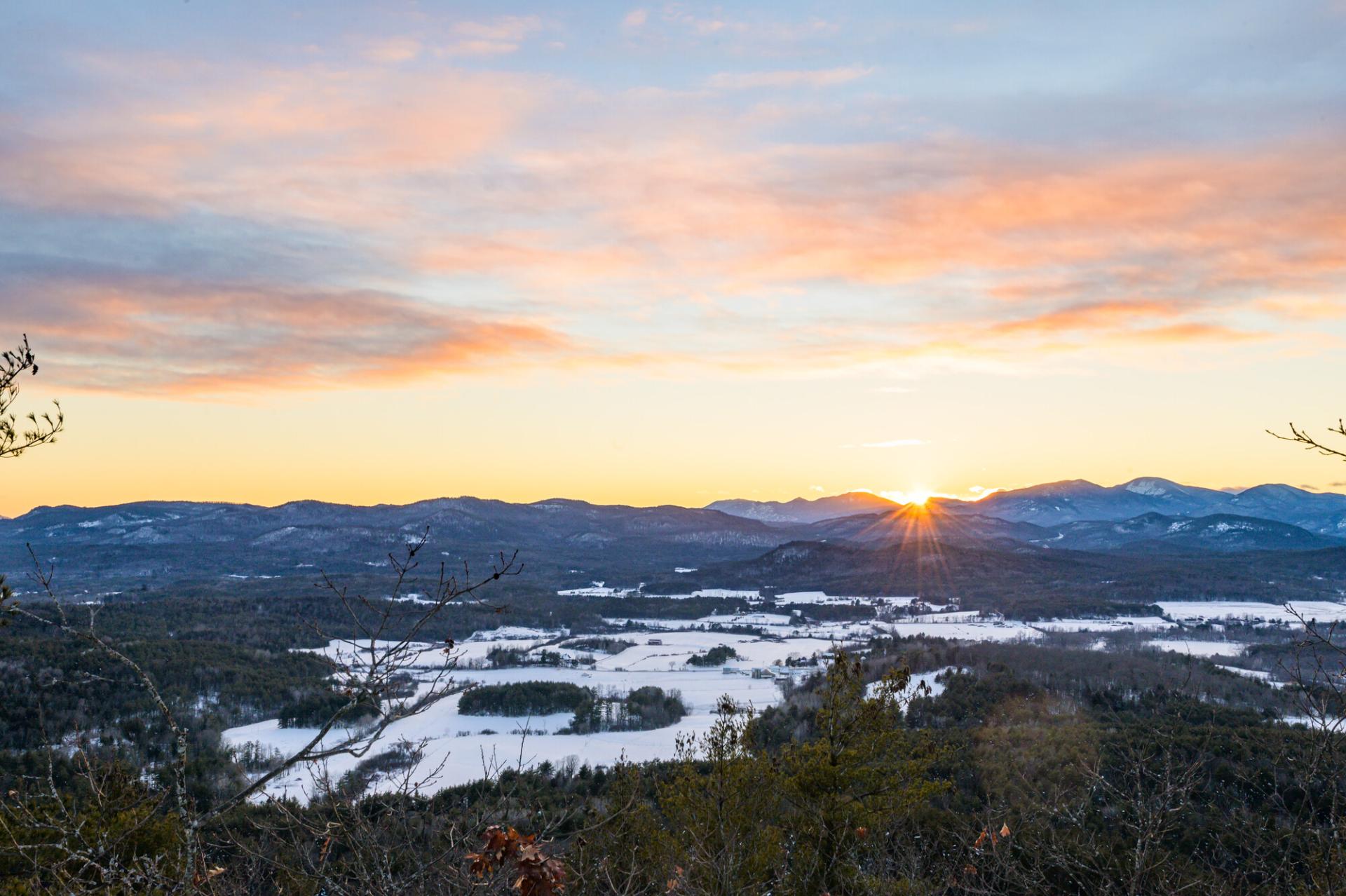 The view from Coon Mountain during a winter sunset.